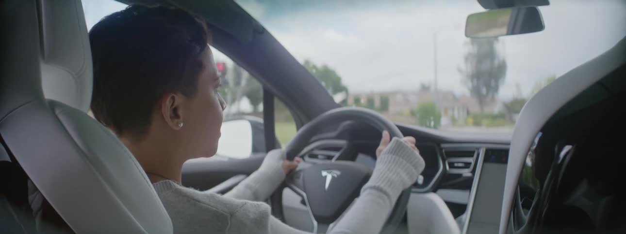 Older woman is driving a car in the middle of the day