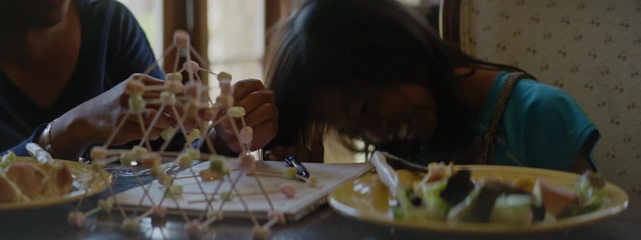 A mother and daughter laugh and build
