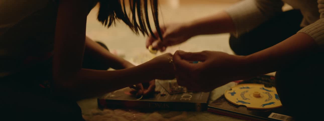 A mother and daughter look through craft supplies