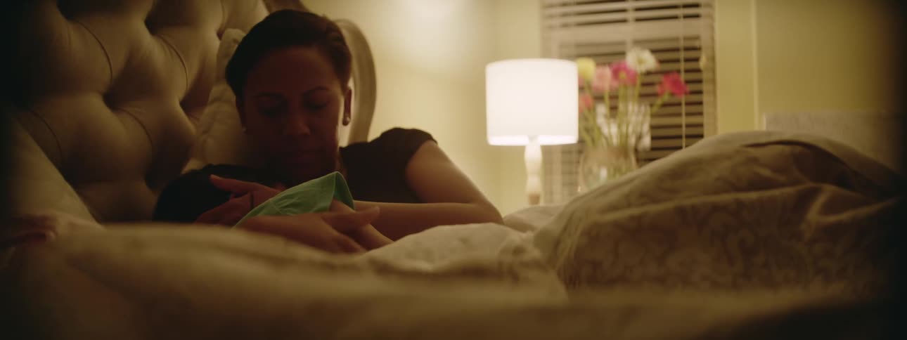 A mother comforts her daughter in bed