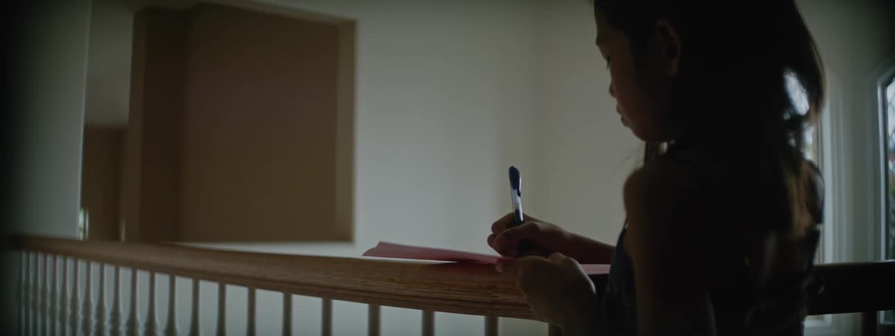 A girl drawing on a paper
