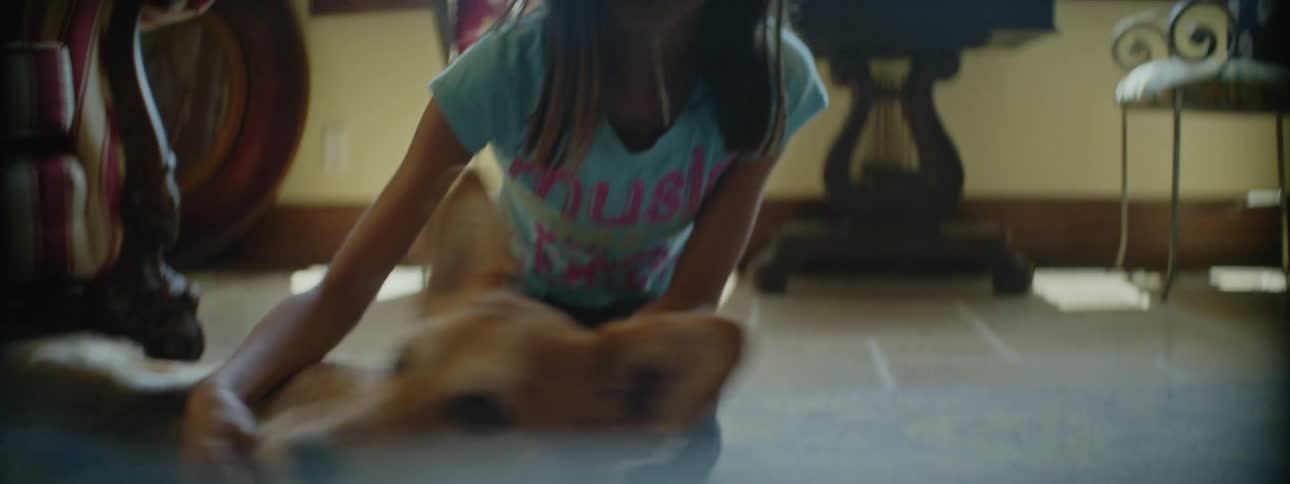 A girl is petting her dog