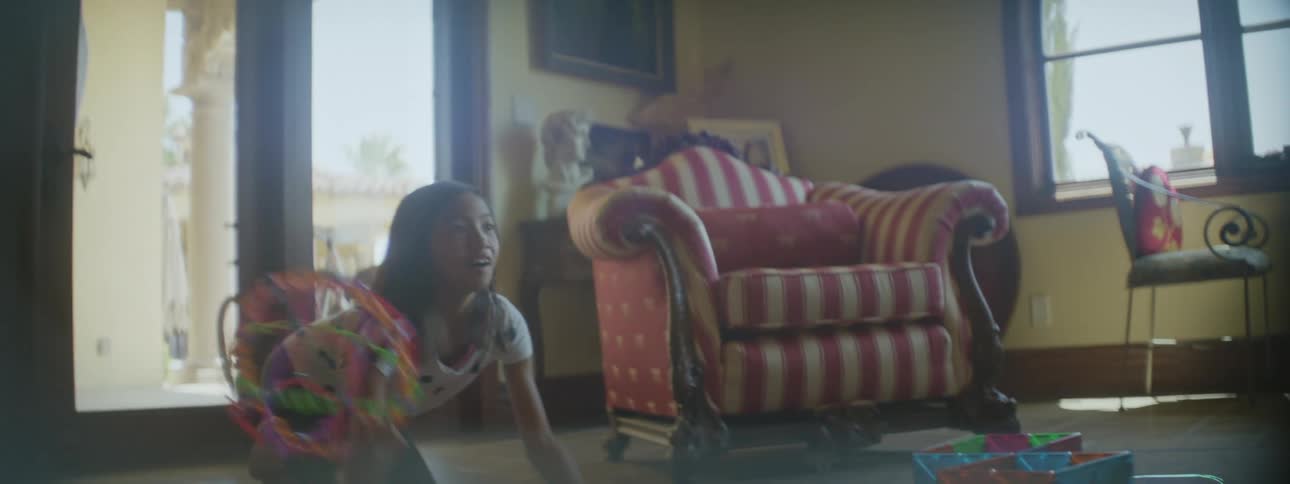 Girl and mother play by tossing toy back and forth at home