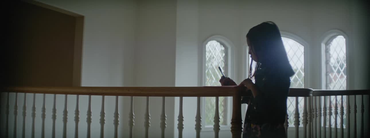 A young child is indoors in the middle of the day time