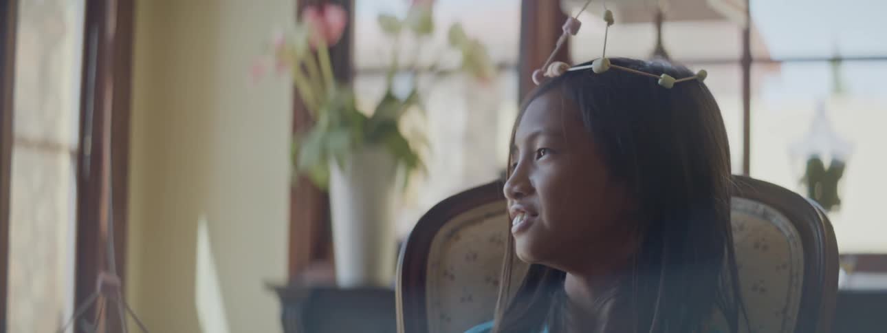 Mother and daughter have fun assembling homemade jewelry