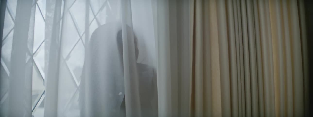 Mother and child are indoors looking at the window