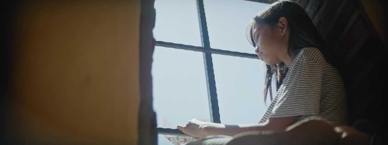 A girl gazes out the window
