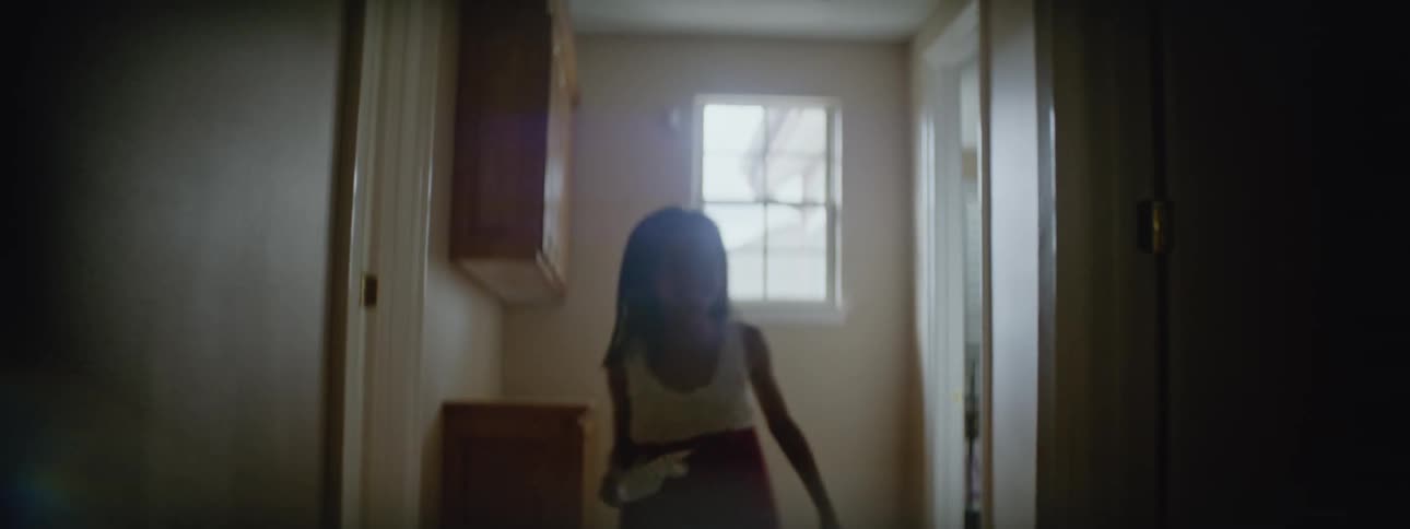 Girl runs inside the house with a paper windmill at daytime