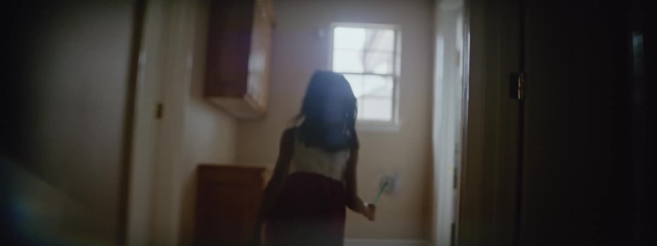 A young kid is running around inside of the house