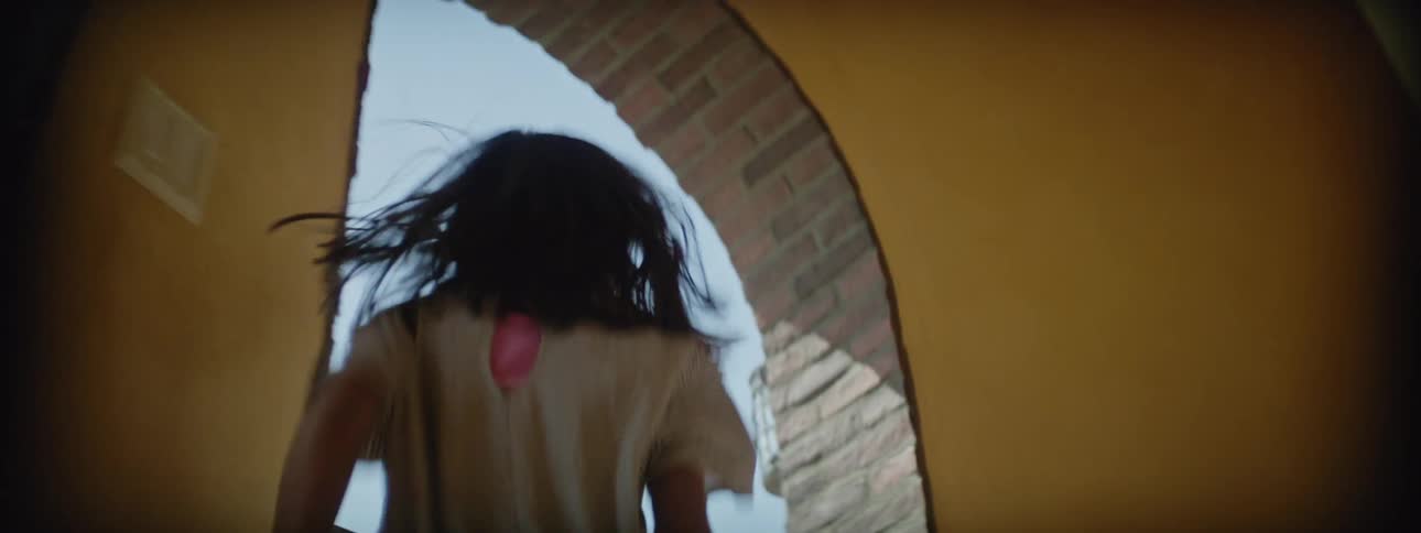 A girl runs up stairs with a paper toy