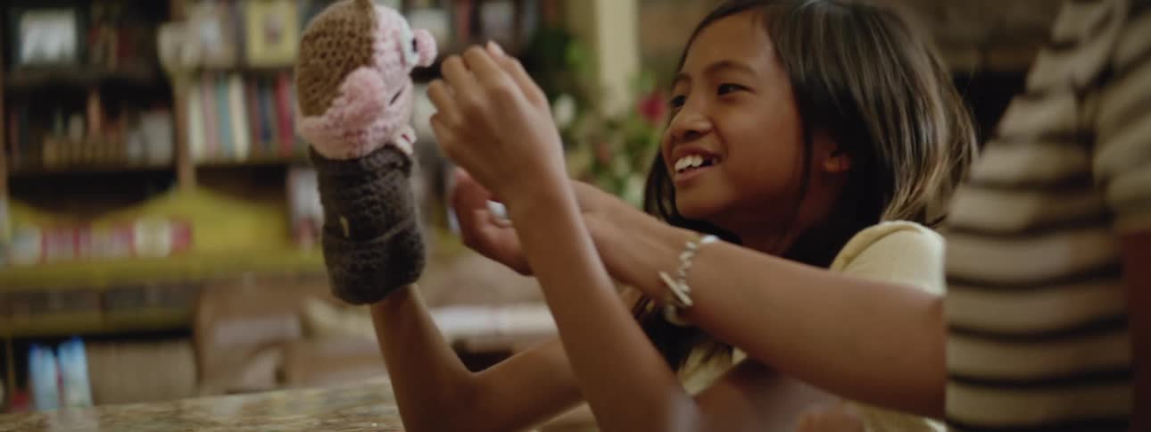 The view is of a kid playing with a puppet