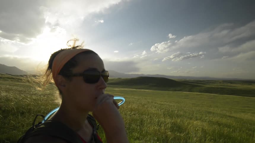 A young woman is walking outdoors around the forest area