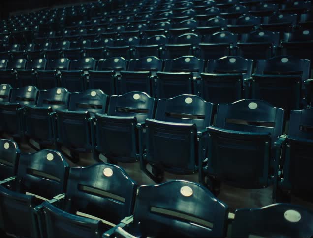 Close up rows of empty stadium seats at night