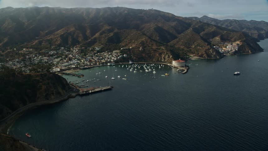 Aerial footage of boats filling Avalon Bay Santa Catalina Island during a partly cloudy day