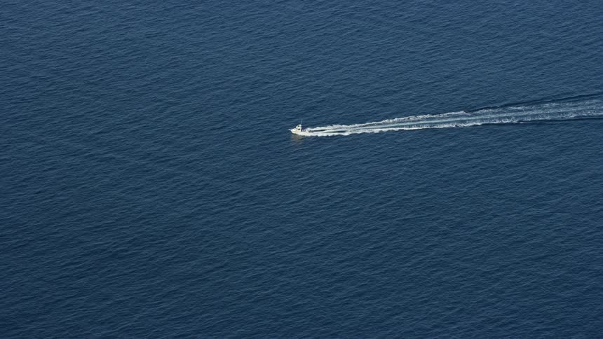 Tracking a fishing boat on open waters off the coast of Southern California during a partly cloudy day