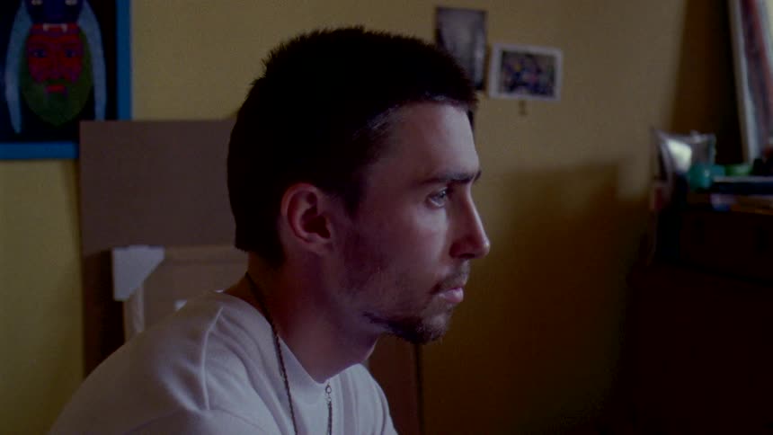 Portrait of a man sitting in a room by himself