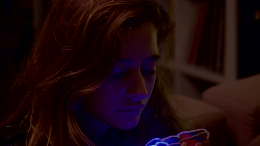 A girl is holding a small flower light