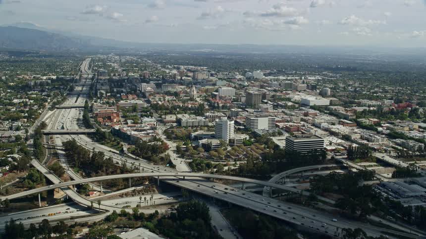 Aerial footage flying over an office building and approaching Pasadena City Hall in Southern California during daytime