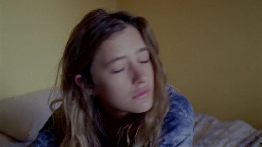 A girl is sitting in bed