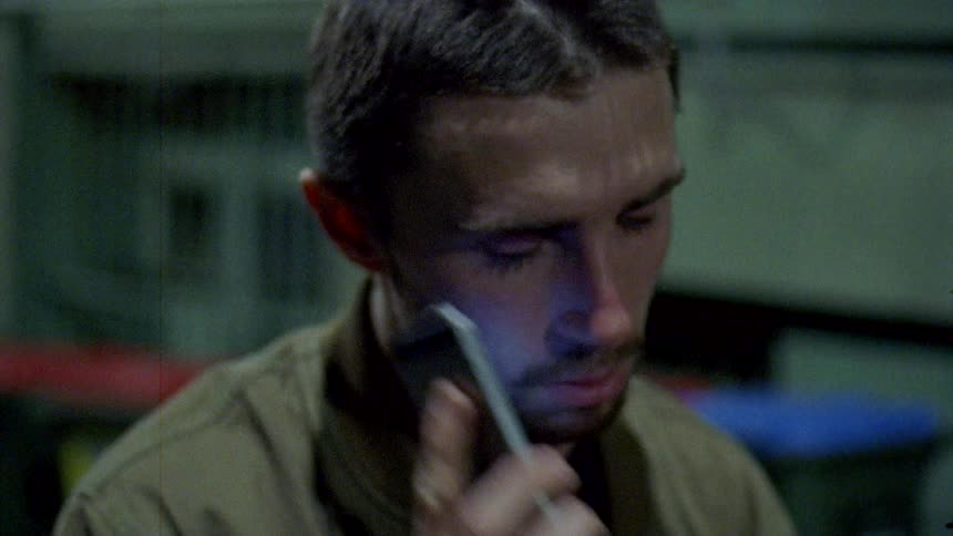 A man paces while making a phone call