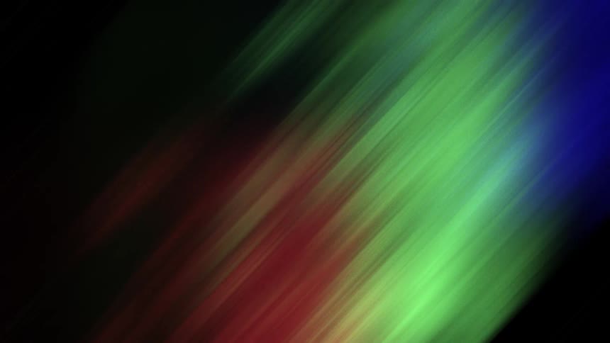 Streaks of colored light glow as they move and illuminate the darkness