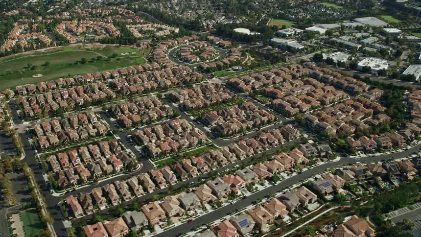 An aerial view of a golf course tract homes and the suburb of Aliso Viejo California with partly cloudy skies
