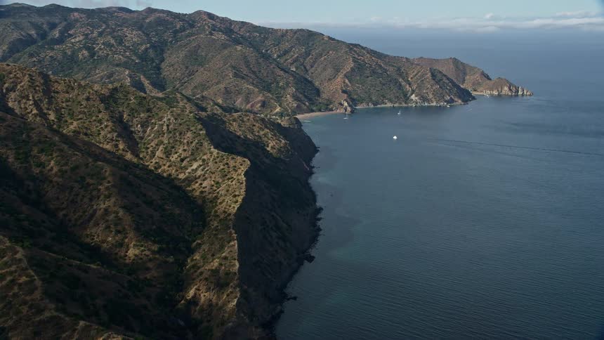 Aerial footage captures the stunning rugged coastline of Santa Catalina Island California ultimately revealing a campground