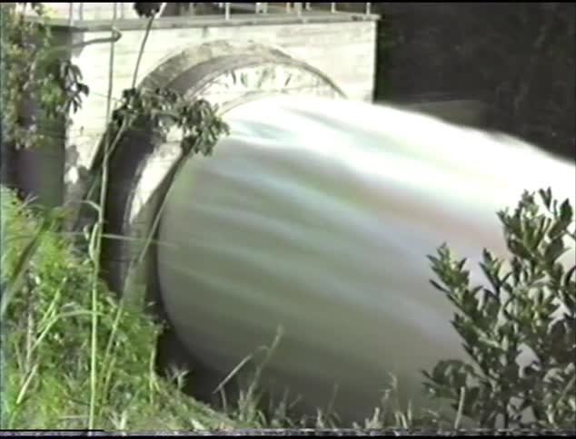 Water crashing through a dam in to a river
