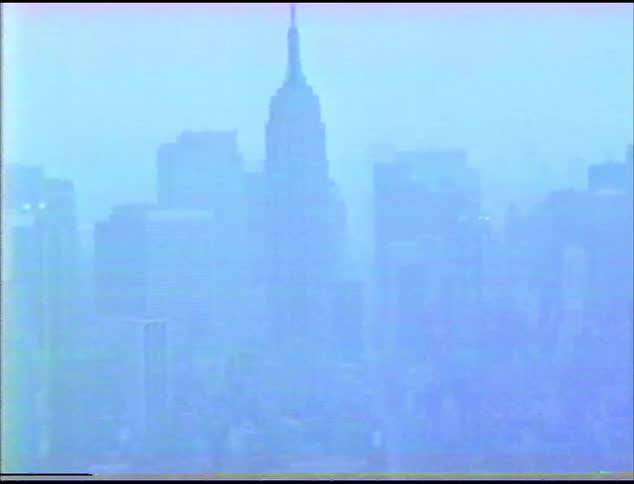 Vintage footage of downtown new york as seen from within a skyscraper on a foggy day