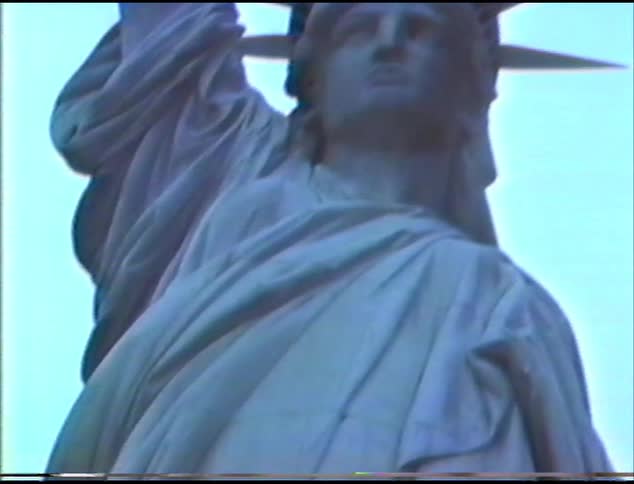 The statue of liberty with the sky and clouds in the background
