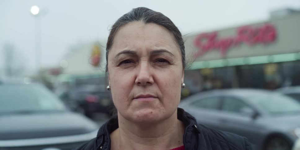 Woman takes off the white face mask in the parking lot