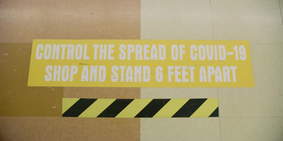 Signage on flooring to social distance while shopping during pandemic