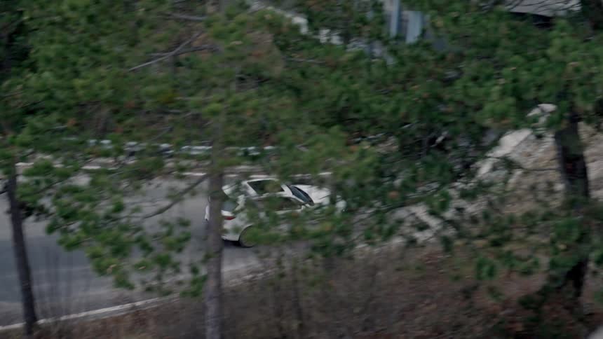 A car is driving through a suburban area