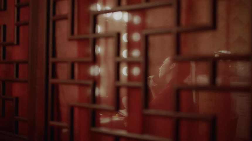 A woman sitting in a dressing room viewed from the doorway