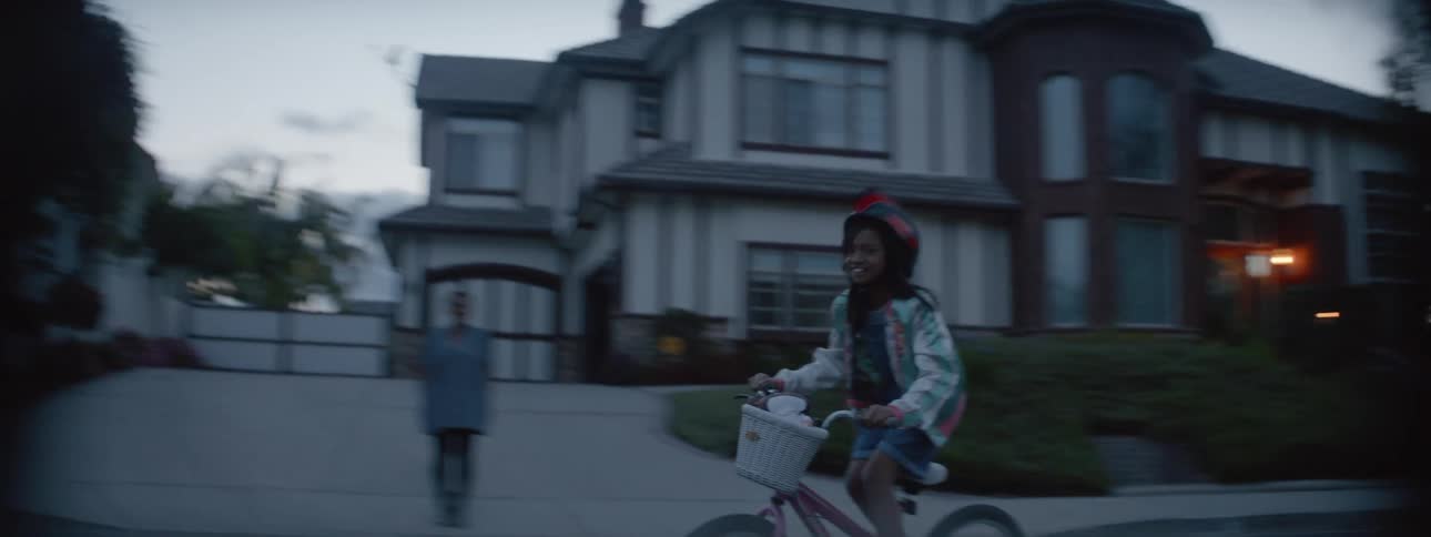 A girl rides her bike on the street