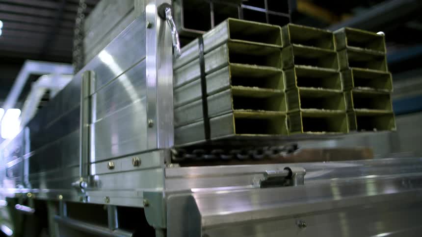Hollow steel bars are lowered into a truck