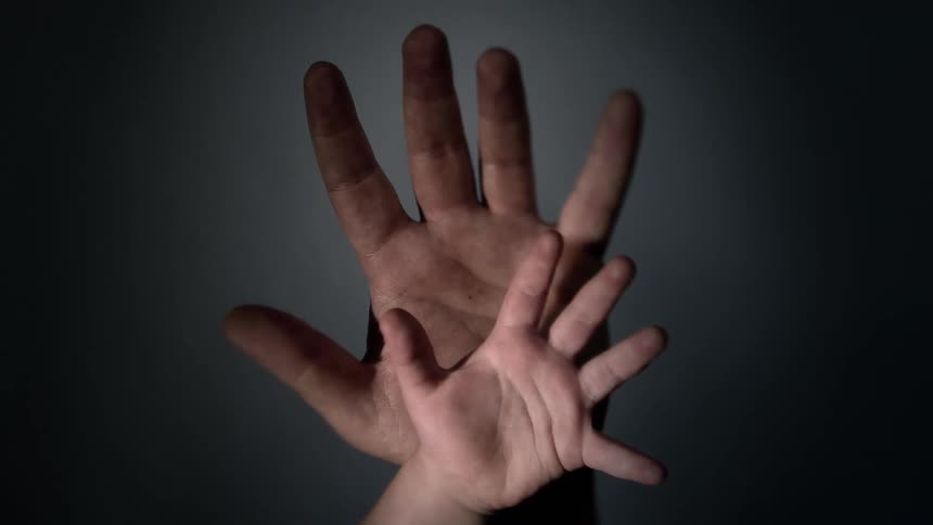 And adult persons hand with achilds hand in front of it