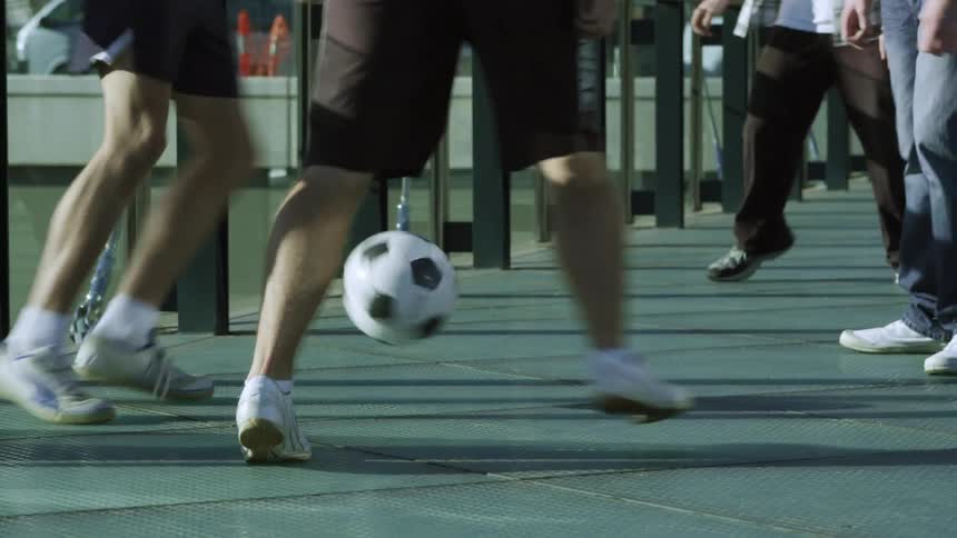 People are playing soccer in the middle of the day time