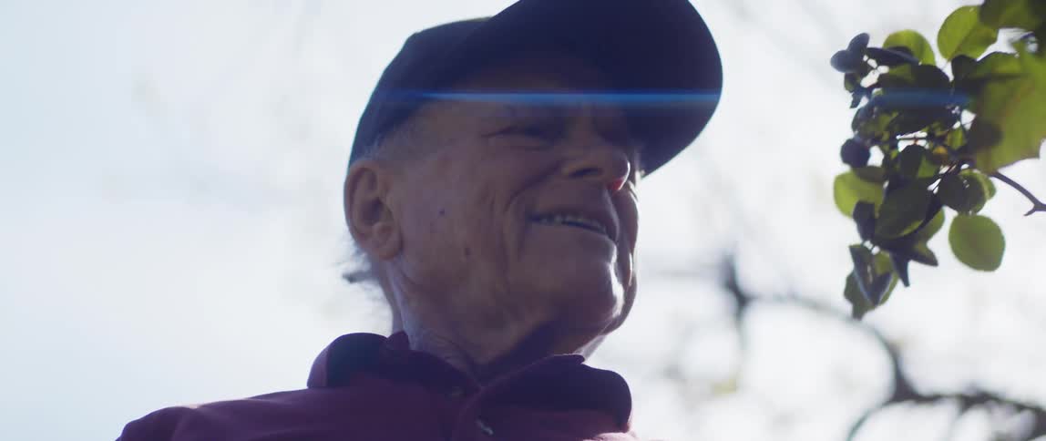 An older elderly man is outdoors in the day time