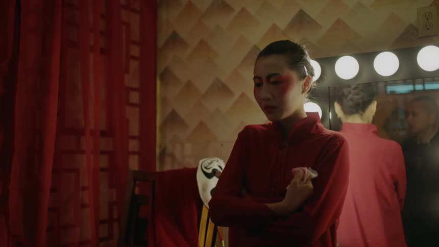 The view is of a young woman that is standing indoors