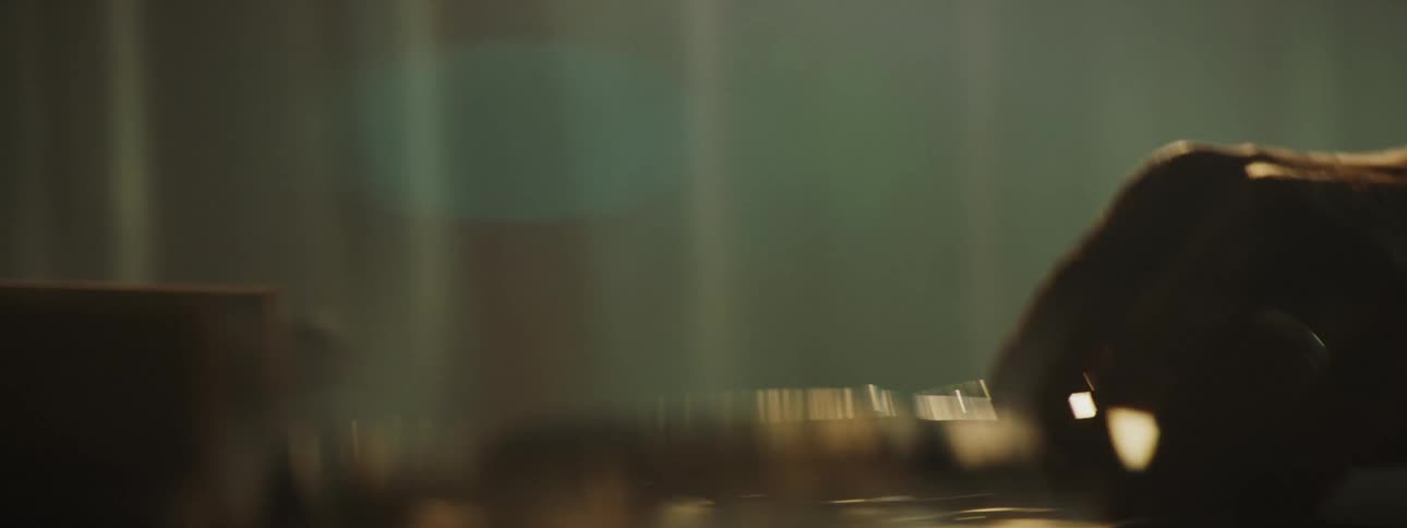A close up of a worker moving a tool from one area to another