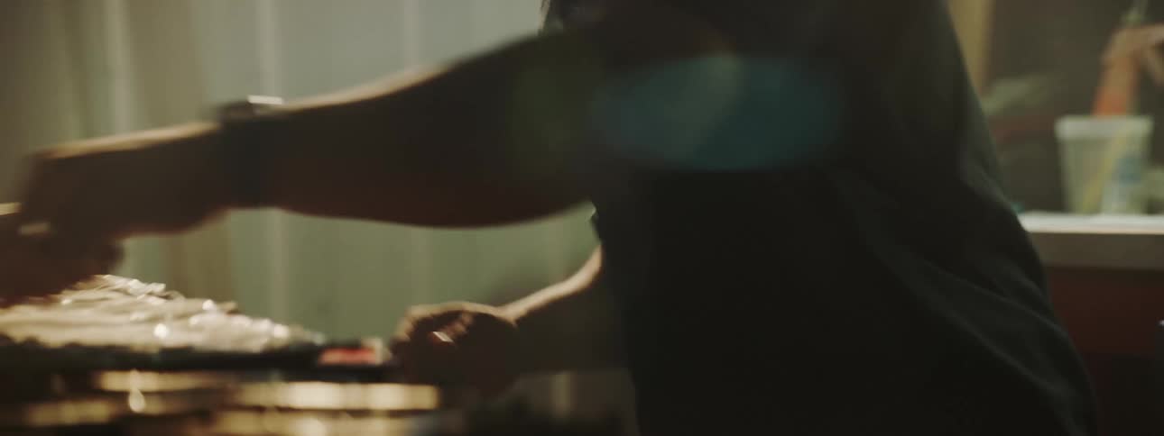 A mechanic reaches for a tool