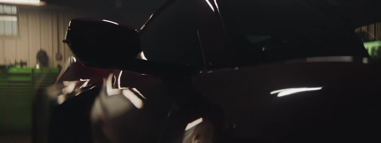 Close up of lights flashing over the shiny body of a luxury sports car