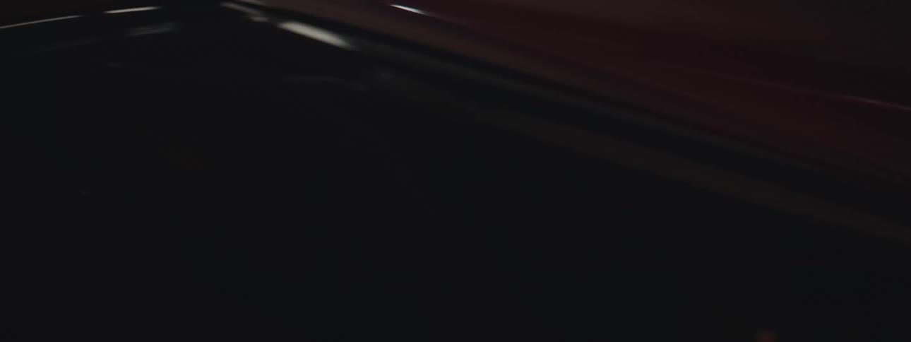 The view is of a shiny red car