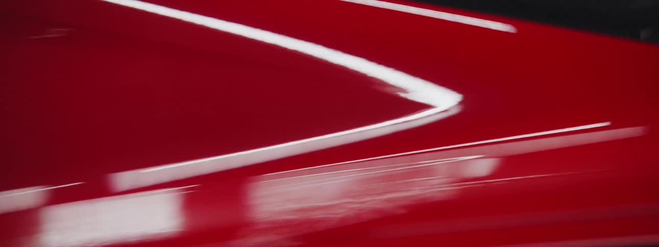 Abstract close up of red sports car with quick shadow wipe reveal and then shadow wipe conceal
