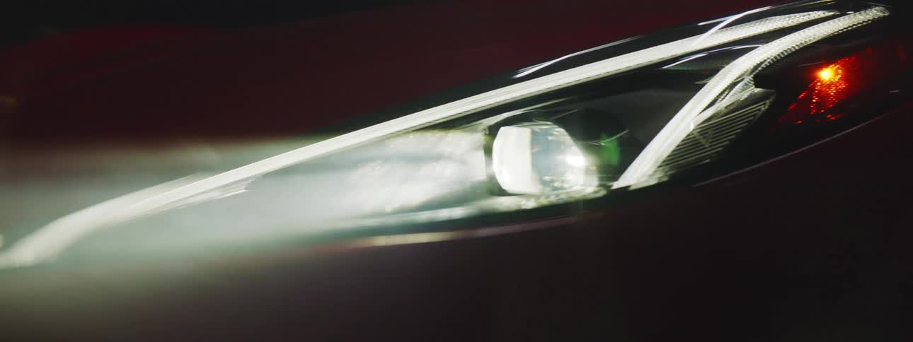 Orbiting close up of the headlights of a modern luxury car