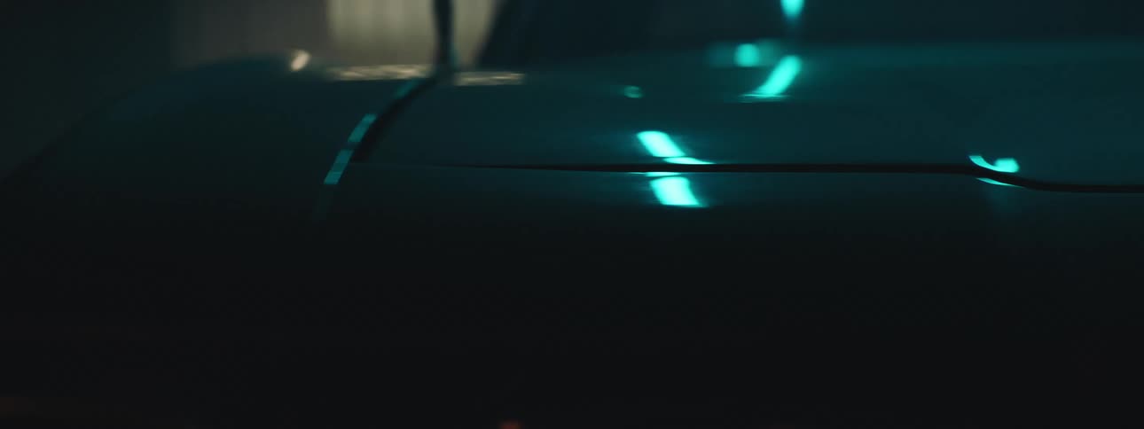 Close up of flashing lights reflecting over the shiny body of a luxury sports car