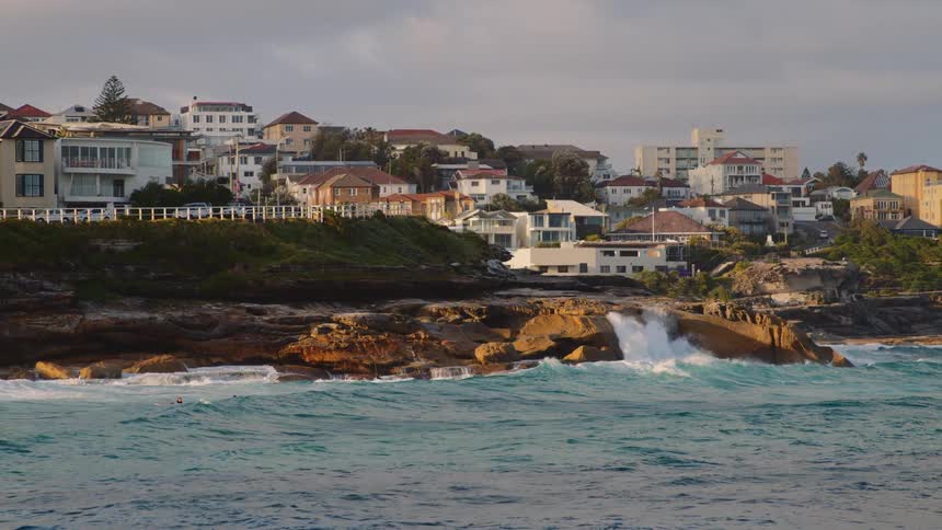 Landscape of shea shore and buildings in the background on a cloudy day