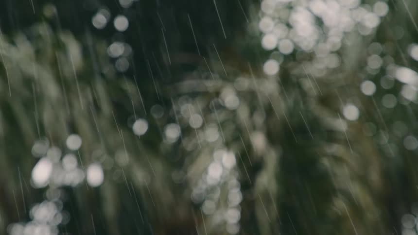 The view is of the outdoors and it is raining outside