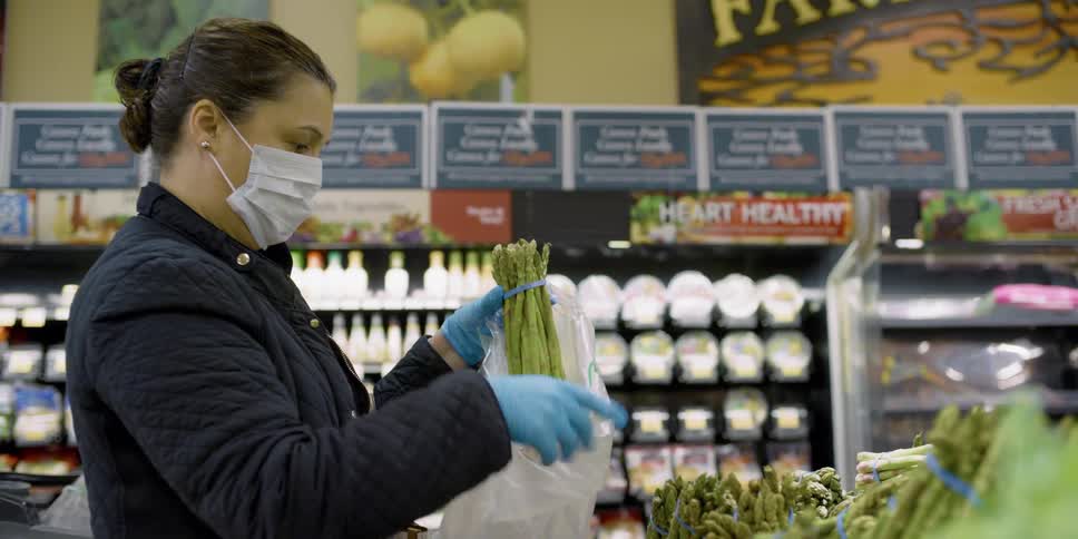 A woman shops for produce